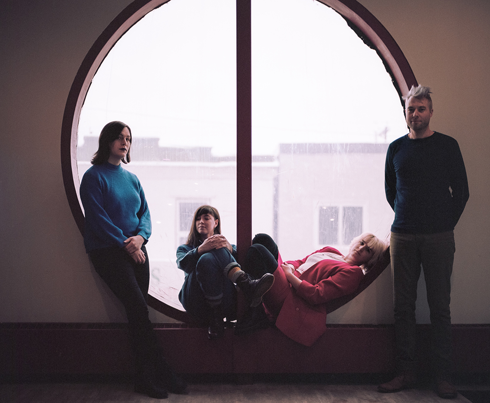Wares band members standing in front of window