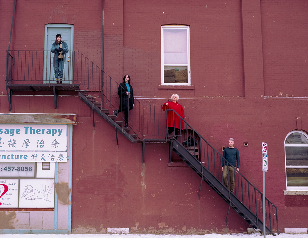 Wares band members standing on staircase