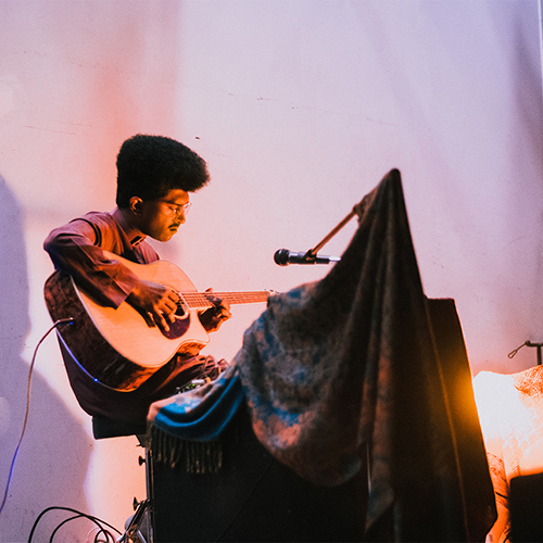person playing guitar at show