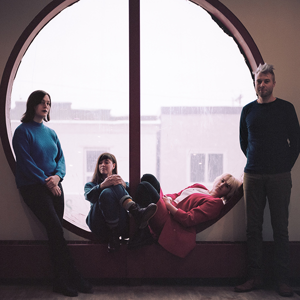 Wares band members standing in front of window